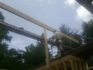 Carpenter setting a ridge beam over a new addition frame — Ice Dam Removal by Roofing Brothers in Mineral Point