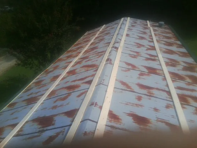 Rusted metal roof panels with new wood purlins before replacement — Storm Damage Roof Repair in Mineral Point by Roofing Brothers